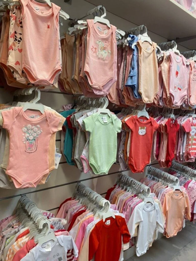 A large kids clothes pallet filled with various new baby and toddler clothing items ready for wholesale.